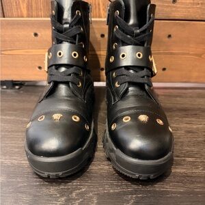 Versace black lace-up combat boots with gold hardware and Medusa insignia